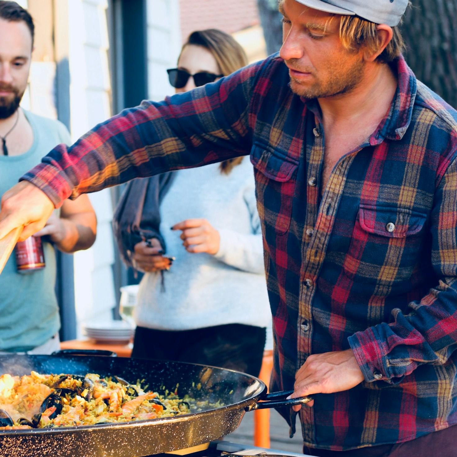 Diverse group of community members sharing a meal, showcasing the bonds formed through collaborative cooking